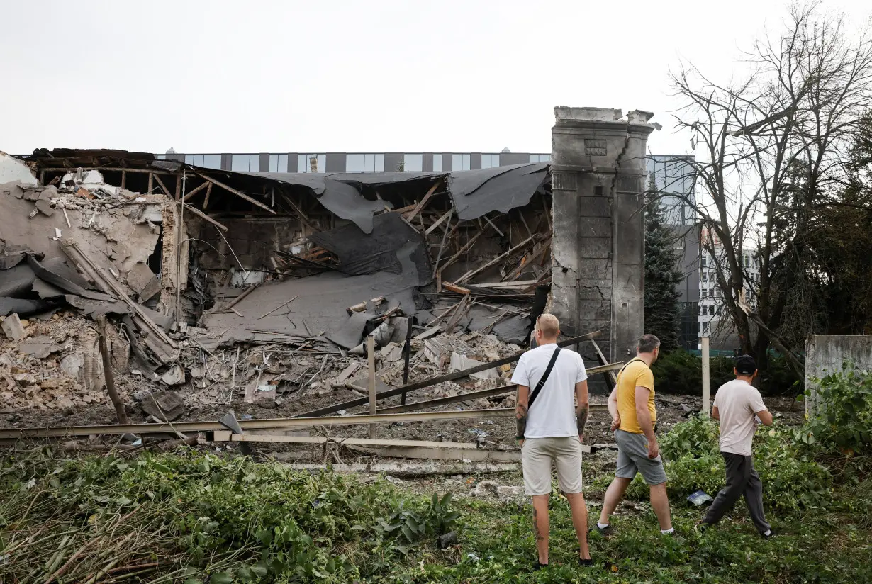 Investigators inspect the site of the Russian missile strike, in Kyiv