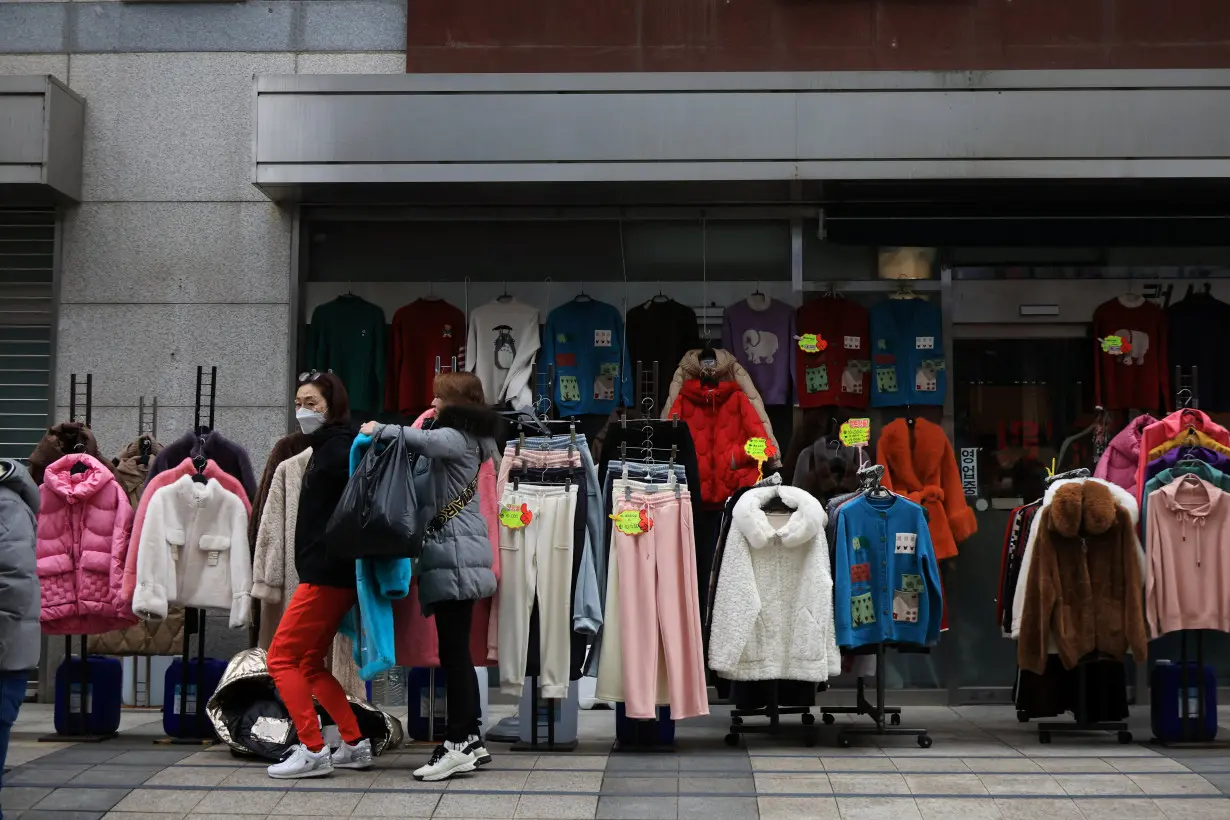 Women shop at a traditional market in Seoul