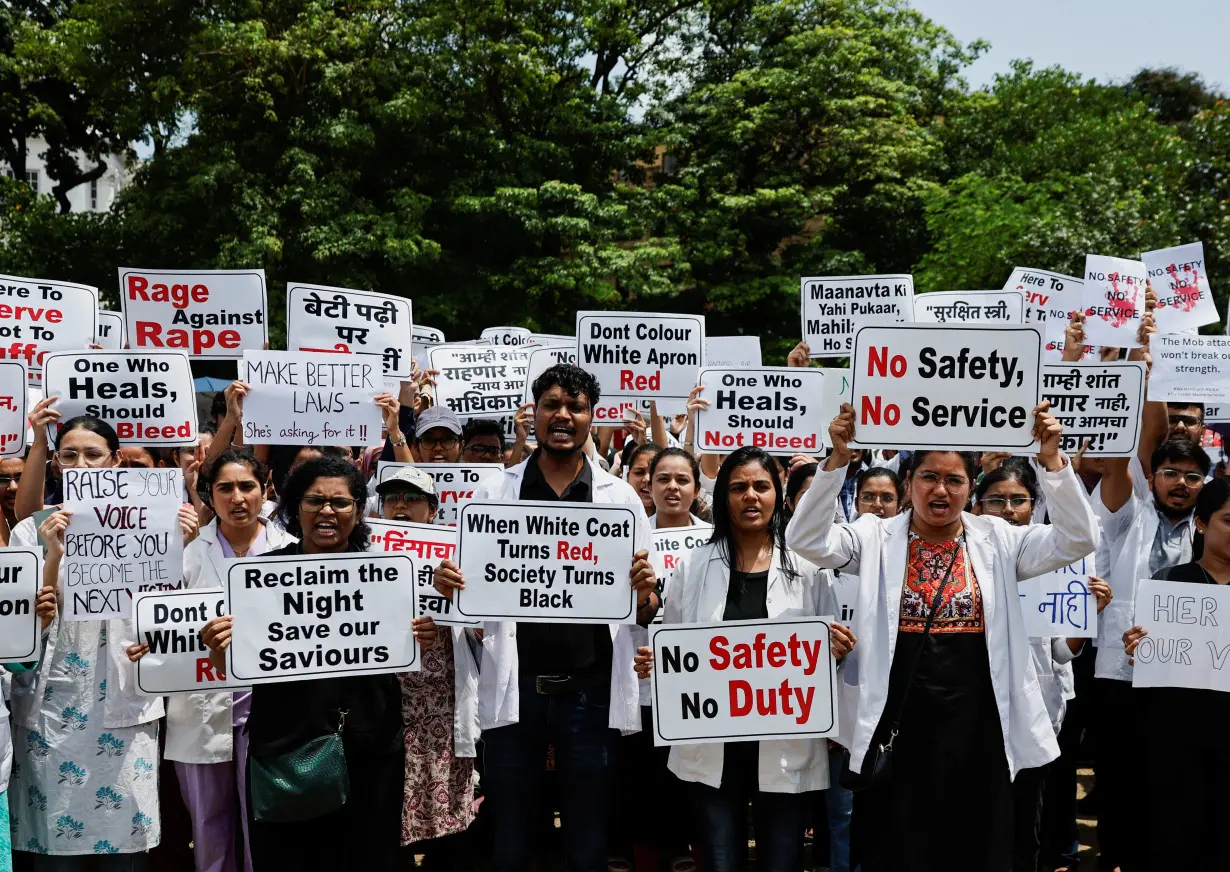 Resident doctors hold posters and shout slogans during a protest, condemning the rape and murder of a trainee medic at a government-run hospital in Kolkata, at a ground in Mumbai