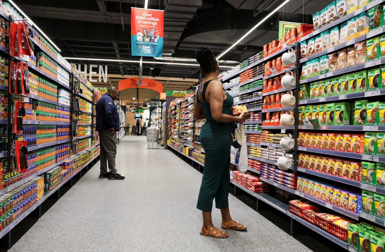 Shoppers look for items as they shop at an outlet of retailer Checkers