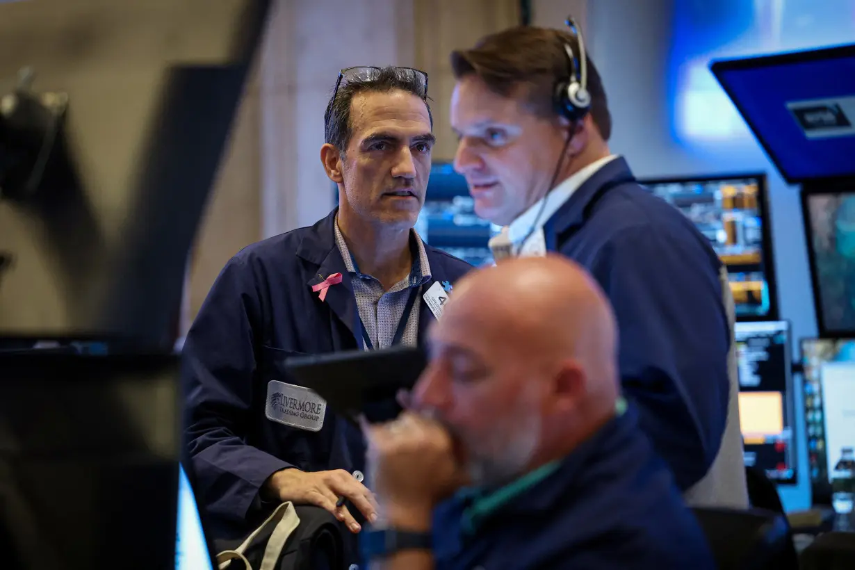 Traders work on the floor of the NYSE in New York