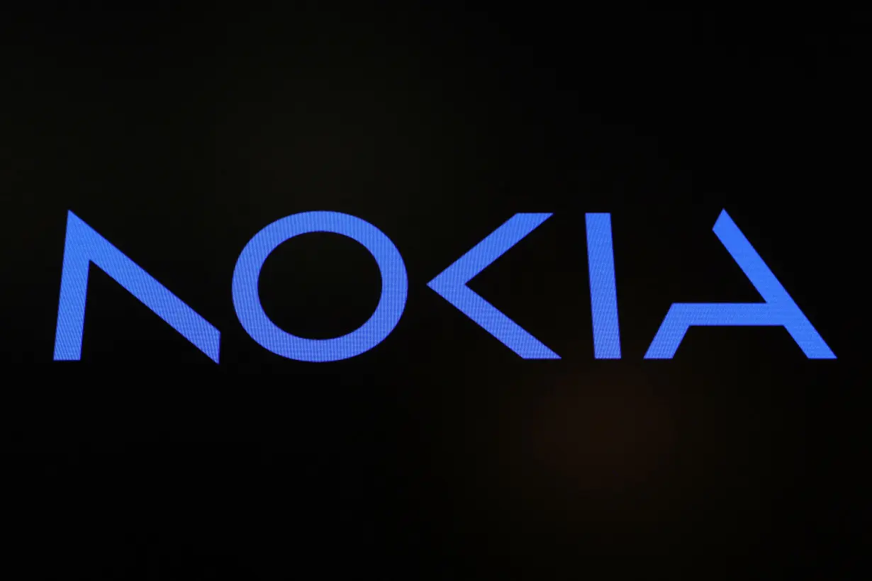 A screen displays the company logo for Nokia Corporation on the floor of the NYSE in New York