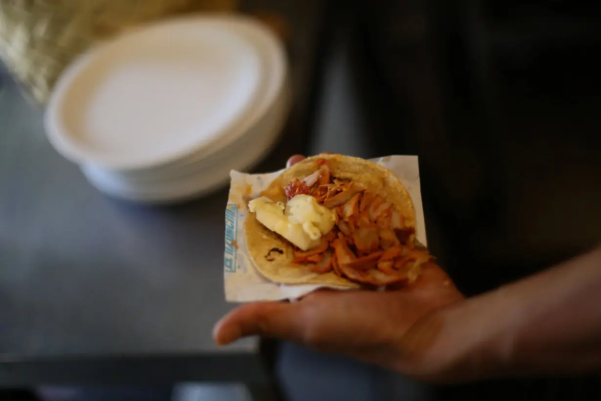 A chef shows a taco at El Tizoncito restaurant in Mexico City