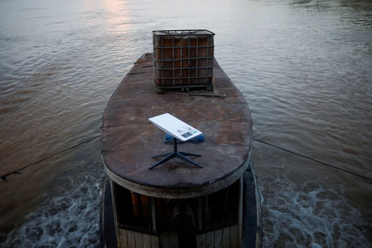 A Starlink satellite internet system is set up on a miners boat on the Madeira River in Porto Velho, Rondonia state, Brazil