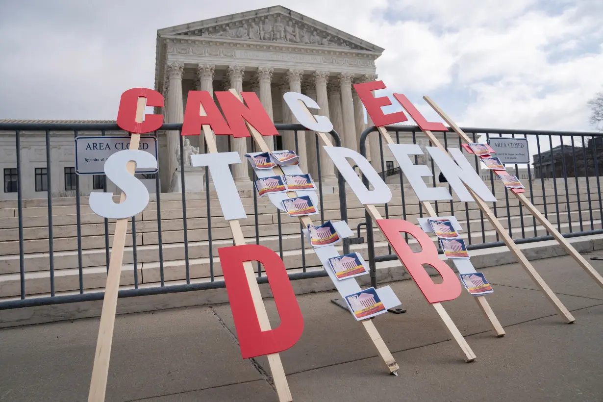 FILE PHOTO: A sign calling for student loan debt relief is seen in front of the Supreme Court