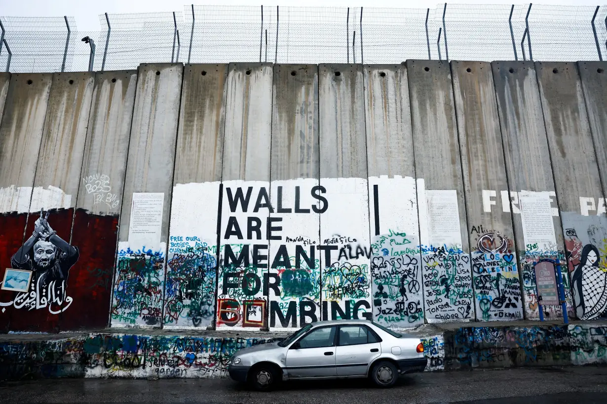 FILE PHOTO: A car is parked next to the Israeli wall in Bethlehem