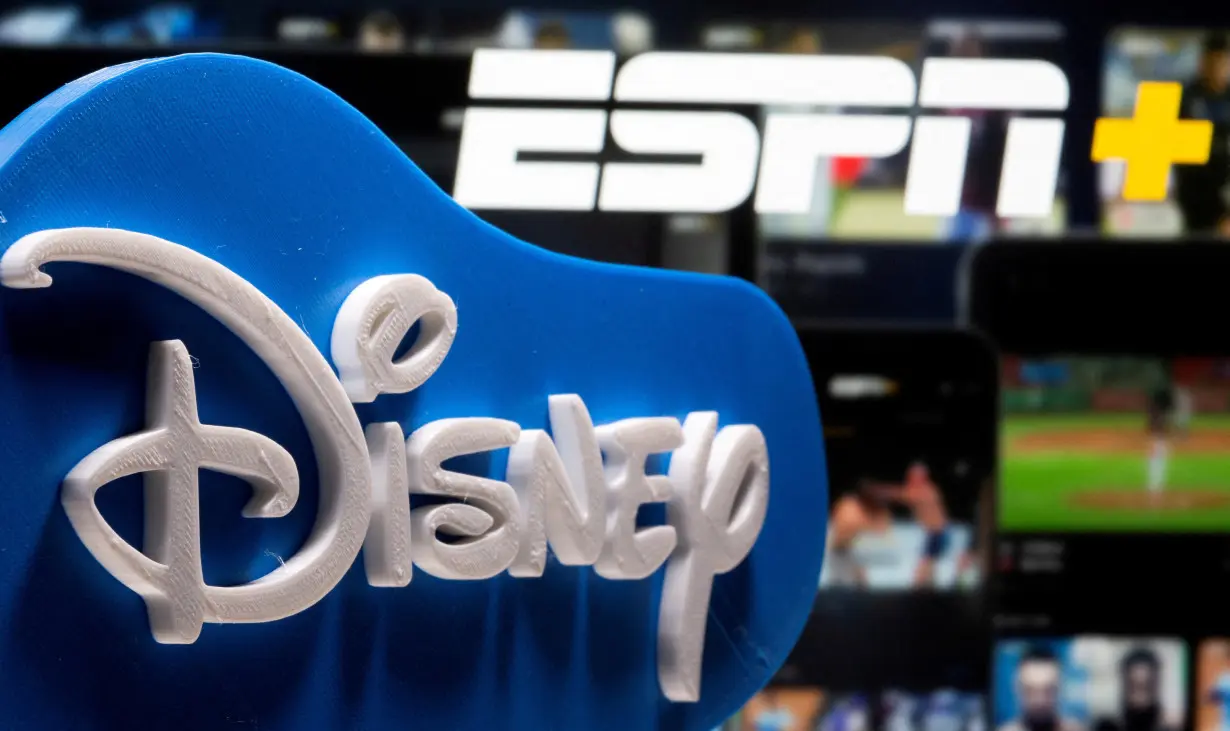 FILE PHOTO: Photo illustration of a 3D printed Disney logo seen in front of the ESPN+ logo