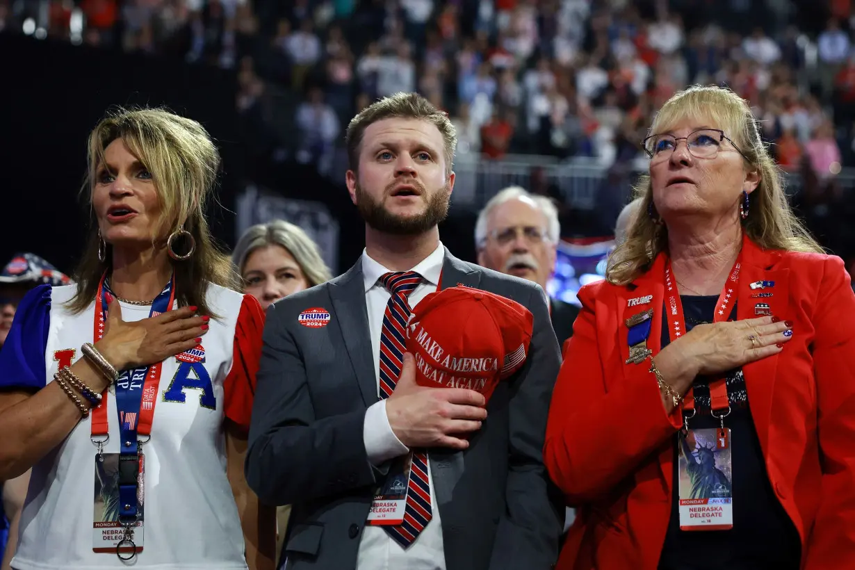 Delegates from Nebraska stand for the National Anthem on the first day of the Republican National Convention at the Fiserv Forum in Milwaukee, Wisconsin on July 15.