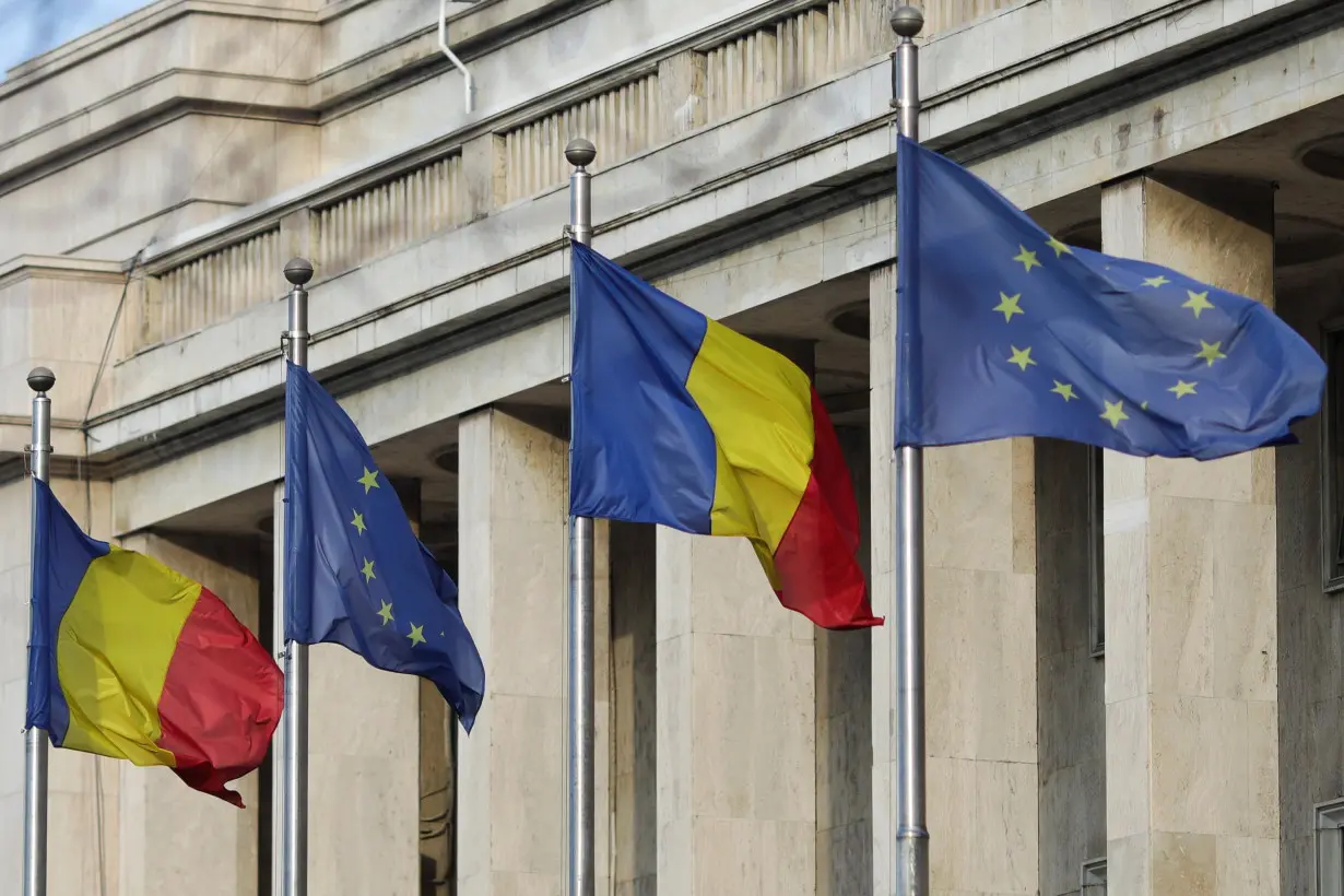 Romanian and EU flags are pictured in front of the headquarters of the Romanian Government