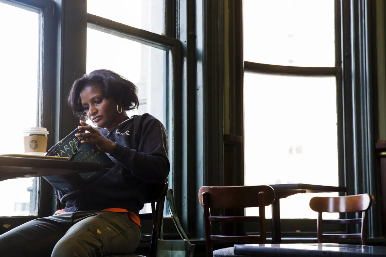 A customer reads a copy of Harper Lee's book 