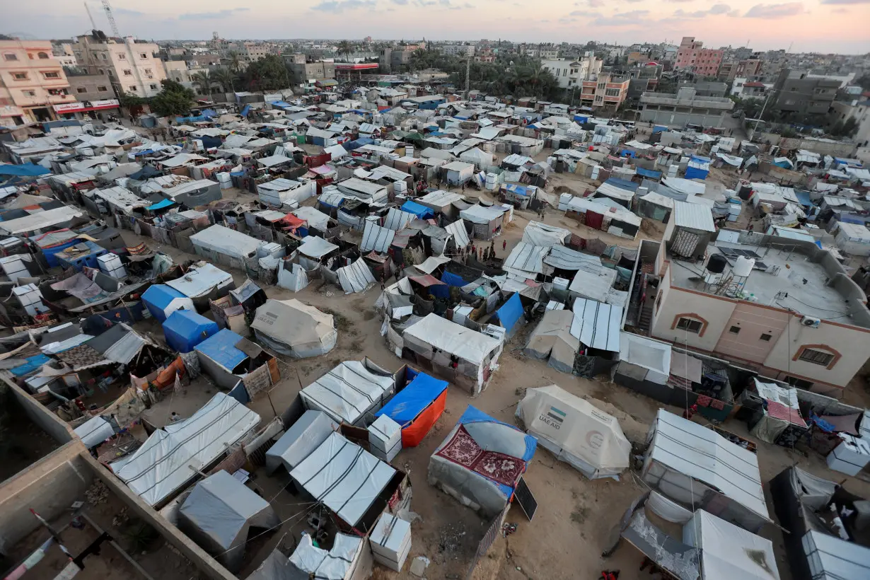 Displaced Palestinians shelter at a tent camp, in Deir Al-Balah