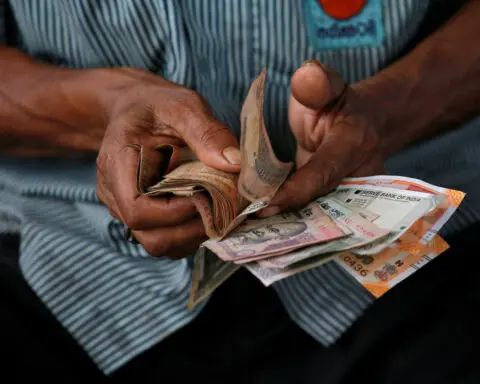 Rupee ends nearly flat as cenbank absorbs importers' dollar demand
