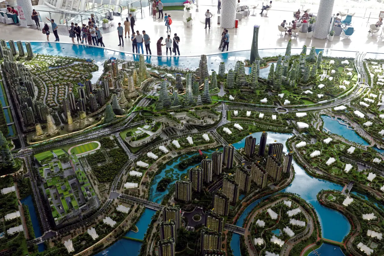 Prospects look at a model of the development at the Country Gardens' Forest City showroom in Johor Bahru