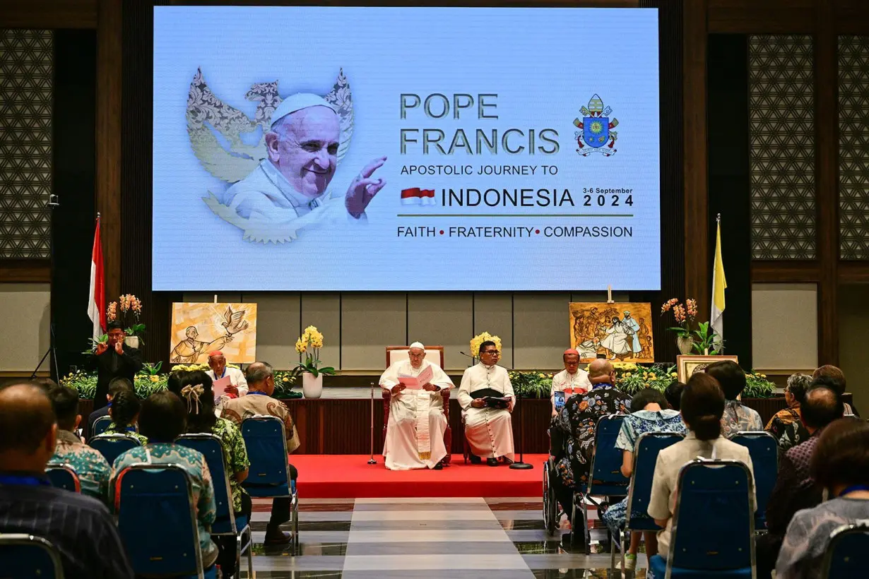 Pope Francis (C) attends an event with beneficiaries of charity organizations at the Bishops' Conference of Indonesia (KWI) office in Jakarta on September 5.