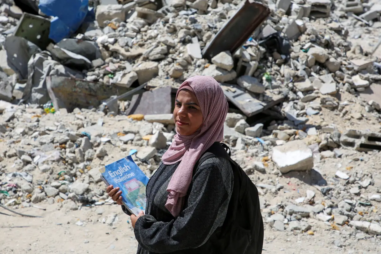 Gaza teacher welcomes students in a classroom tent set up on the rubble of her house