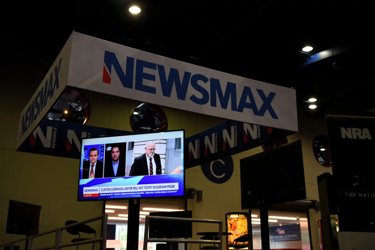 FILE PHOTO: A Newsmax booth broadcasts