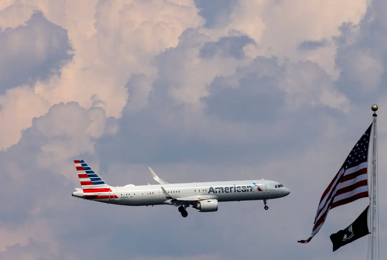 An American Airlines commercial aircraft flies over Washington as it approaches to land at Dulles International Airport