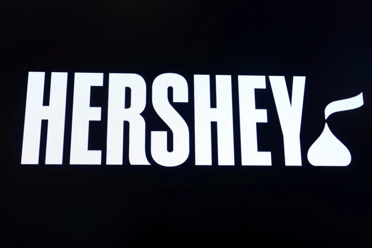 The company logo for Hershey Co. is displayed on a screen on the floor of the NYSE in New York