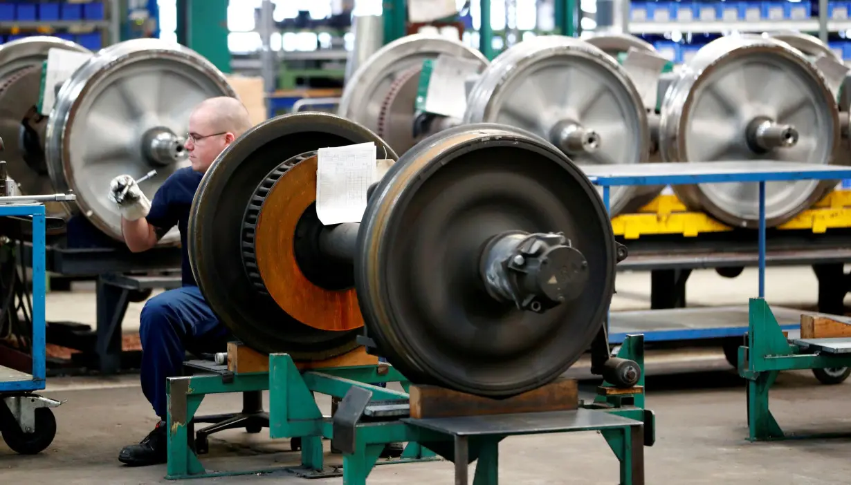 A worker works on parts of S-Bahn commuter city train at German railway operator Deutsche Bahn's maintenance plant Schoeneweide in Berlin