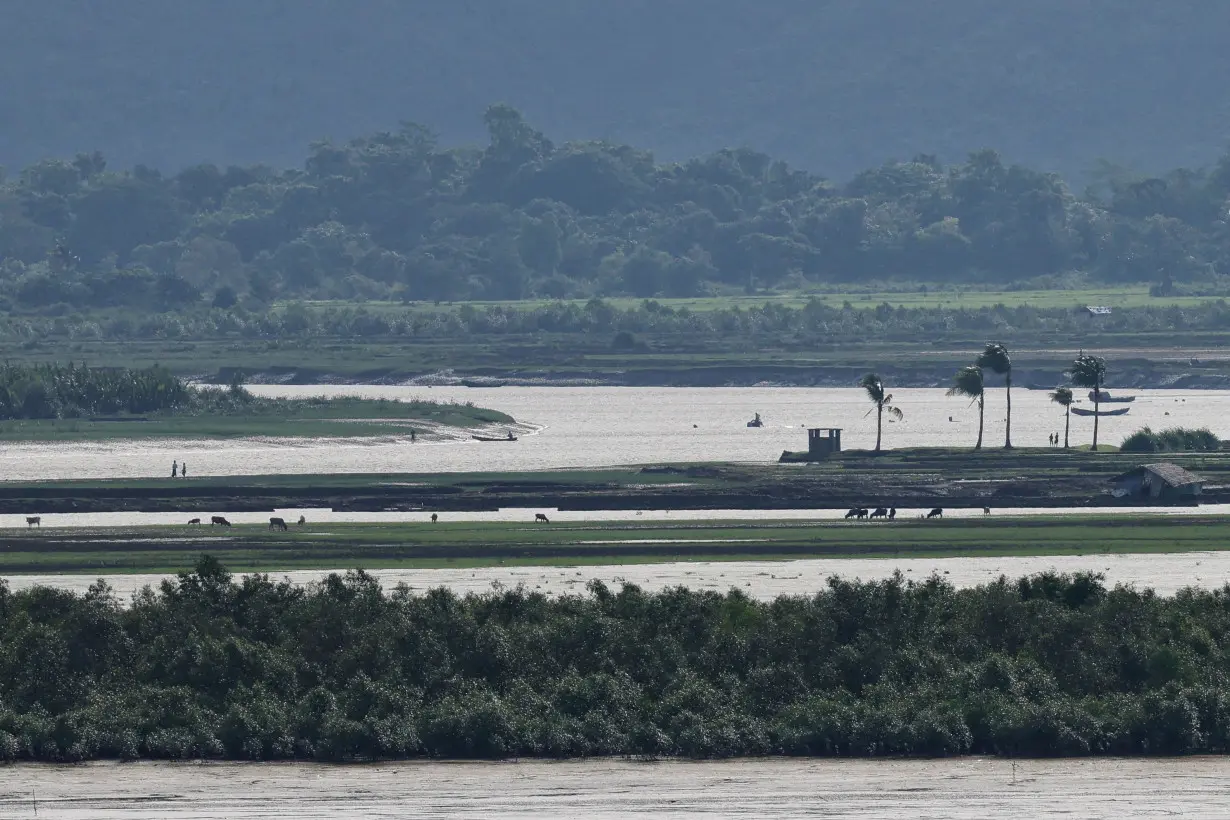 FILE PHOTO: People of Maungdaw township of Myanmar are seen from the Teknaf area of Bangladesh, at the Myanmar-Bangladesh border