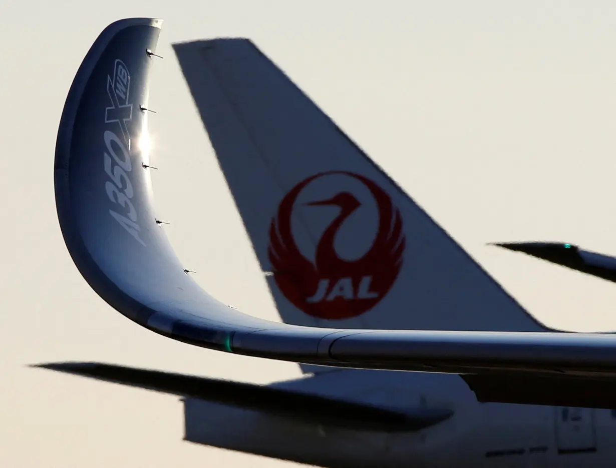 Wing of an Airbus A350 XWB aircraft is seen in front of a JAL aircraft after landing for its market survey at Haneda airport in Tokyo