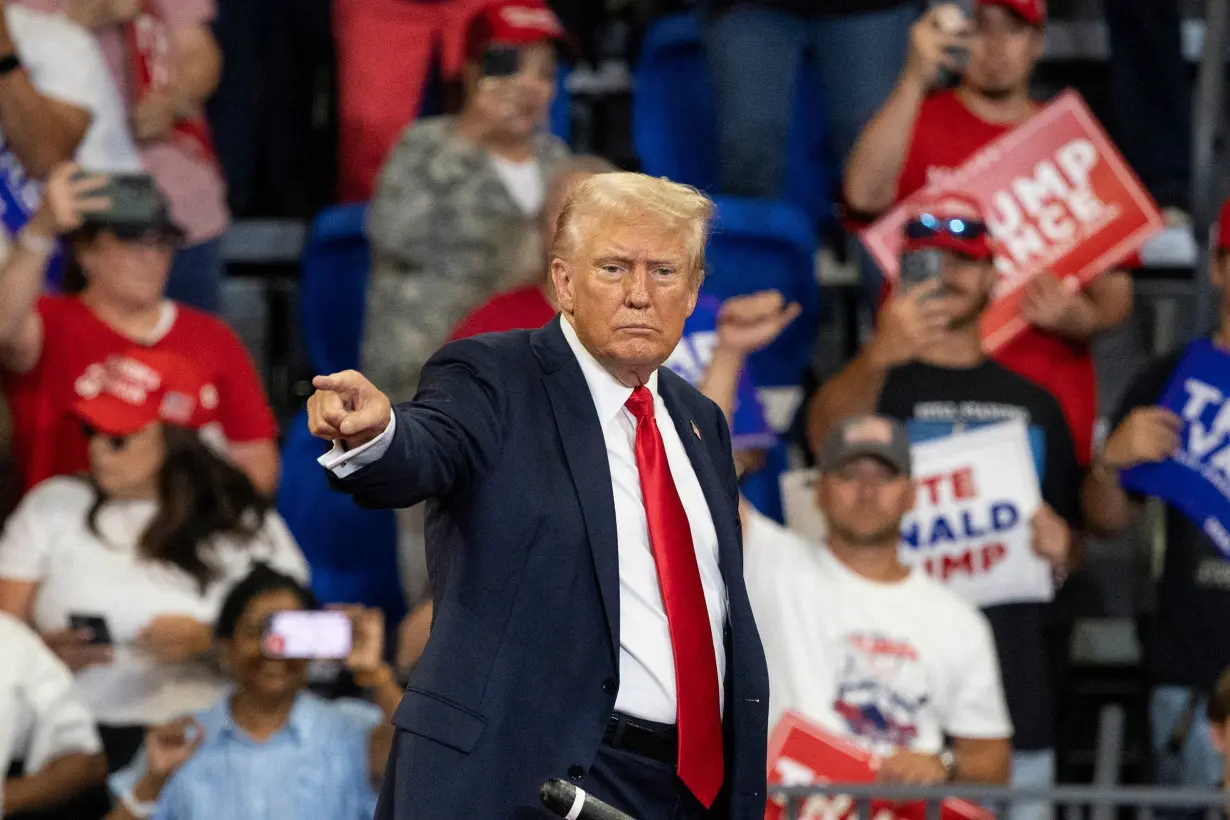 Former President Donald Trump points to the crowd as he leaves after a campaign rally at the Georgia State Convocation Center in Atlanta on August 3.