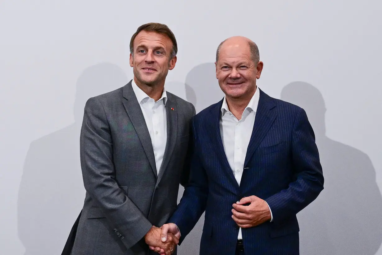 France's President Emmanuel Macron and Germany's Chancellor Olaf Scholz meet during the 33rd Evian Annual Meeting to promote economic cooperation at Evian