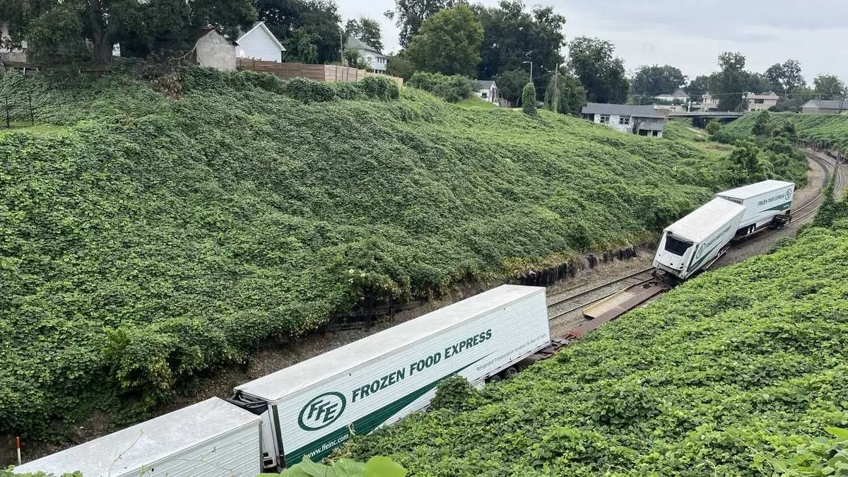 Train derails, trapping man underneath