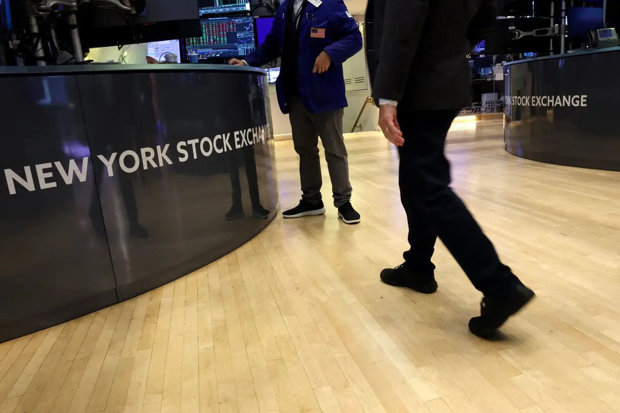 Traders work on the floor of the NYSE in New York