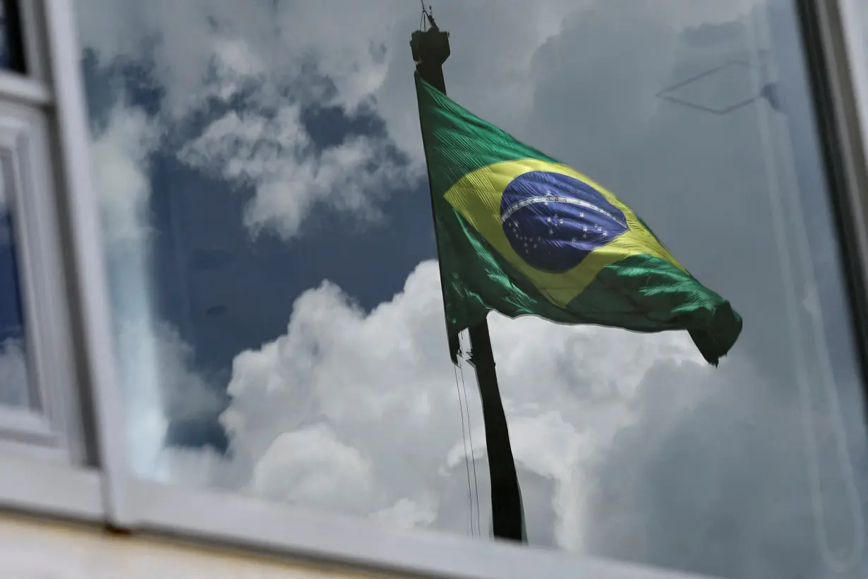 Brazil's flag is reflected in a window at the Planalto Palace, almost one year after the protest of January 8 in Brasilia