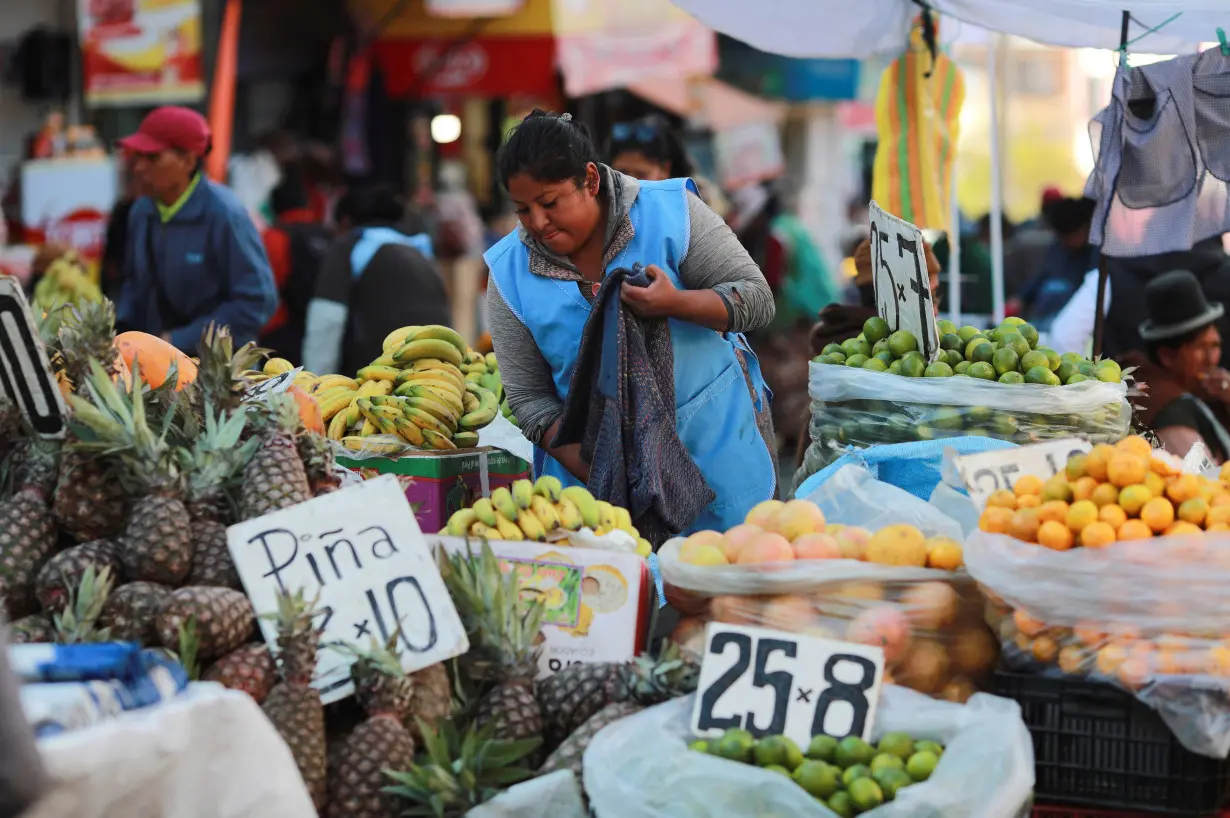 A street seller waits for customers along a street, in La Paz