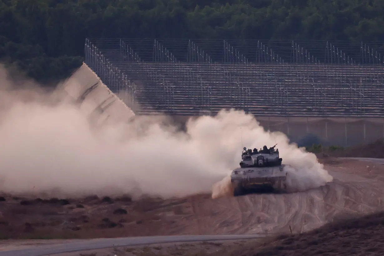 A tank manoeuvres on the Israeli side of the Israel-Gaza border