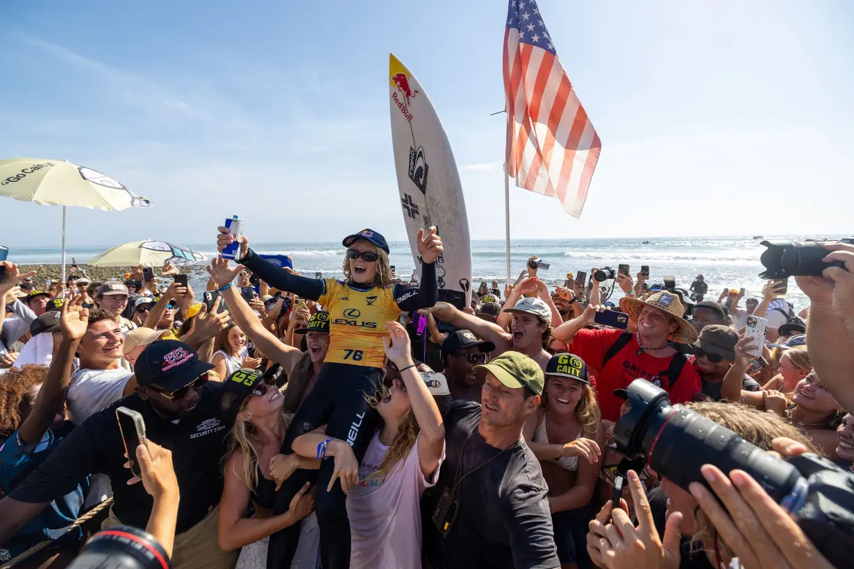 Caitlin Simmers is carried on the beach after beating Caroline Marks to win the WSL Finals.