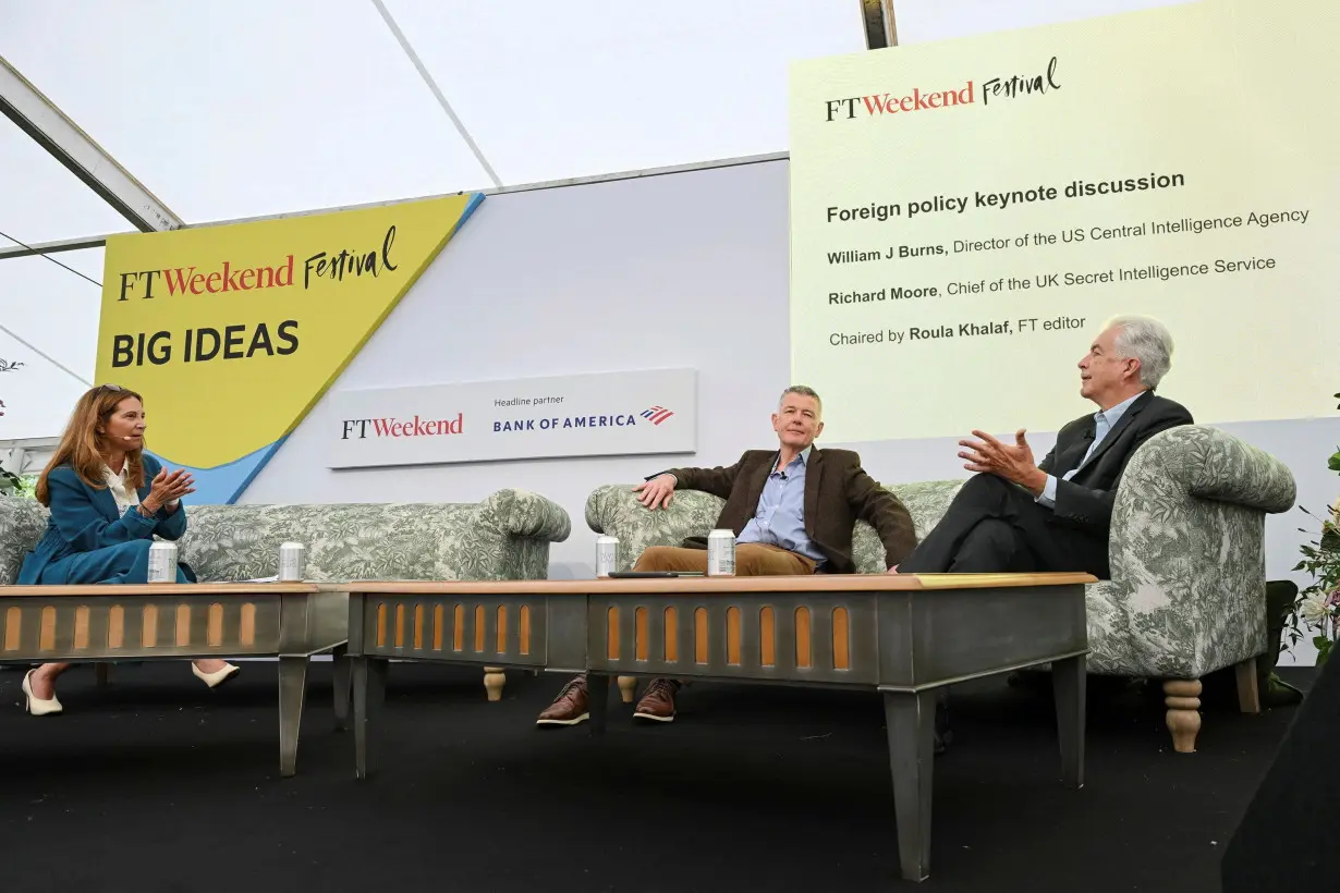 MI6 chief Richard Moore, center, and CIA director Bill Burns, right, are interviewed by Roula Khalaf, editor of the Financial Times, on September 7.