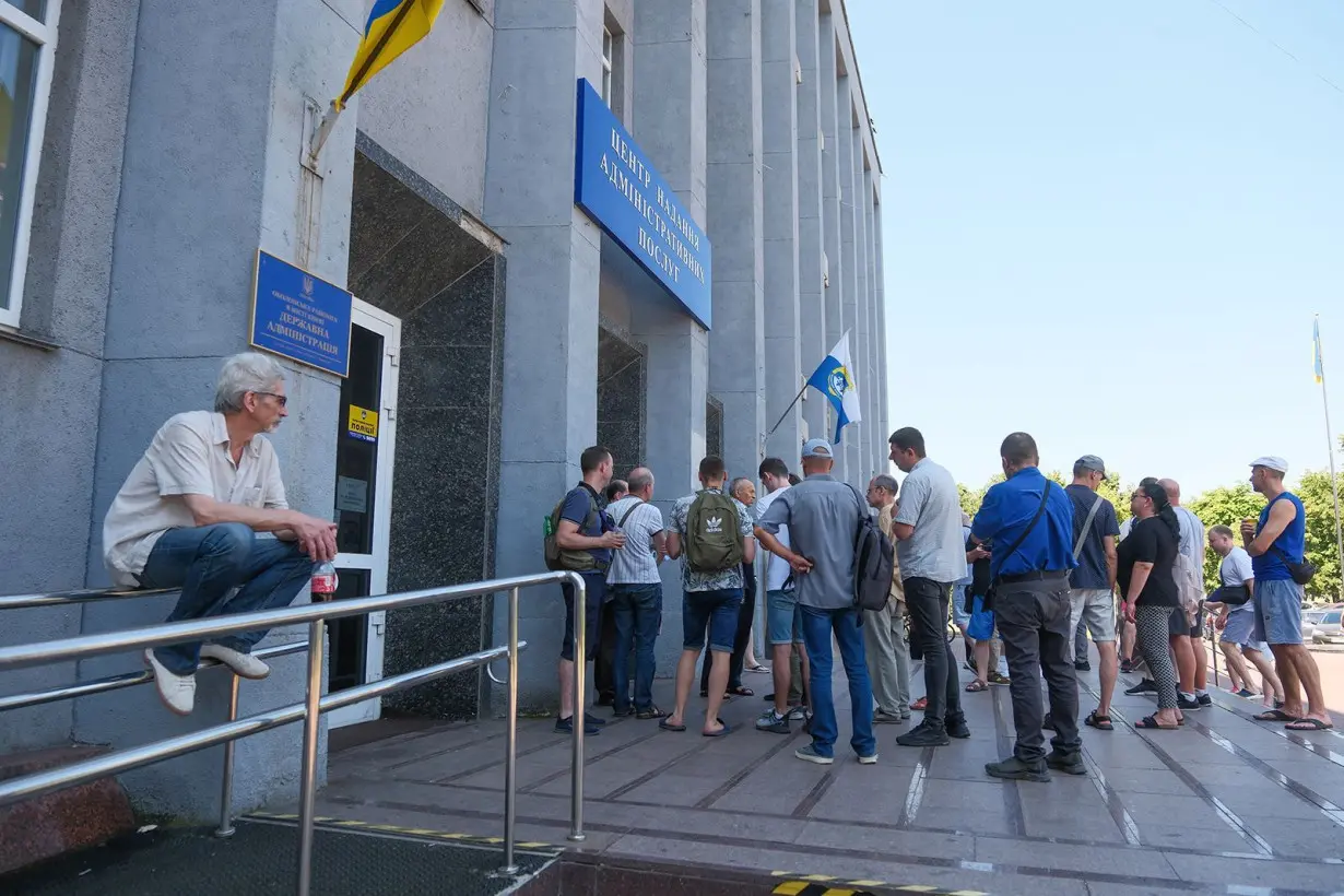 Ukrainian conscripts wait in lines outside the Administrative Services Center to update their registration data on July 12 in Kyiv, Ukraine.