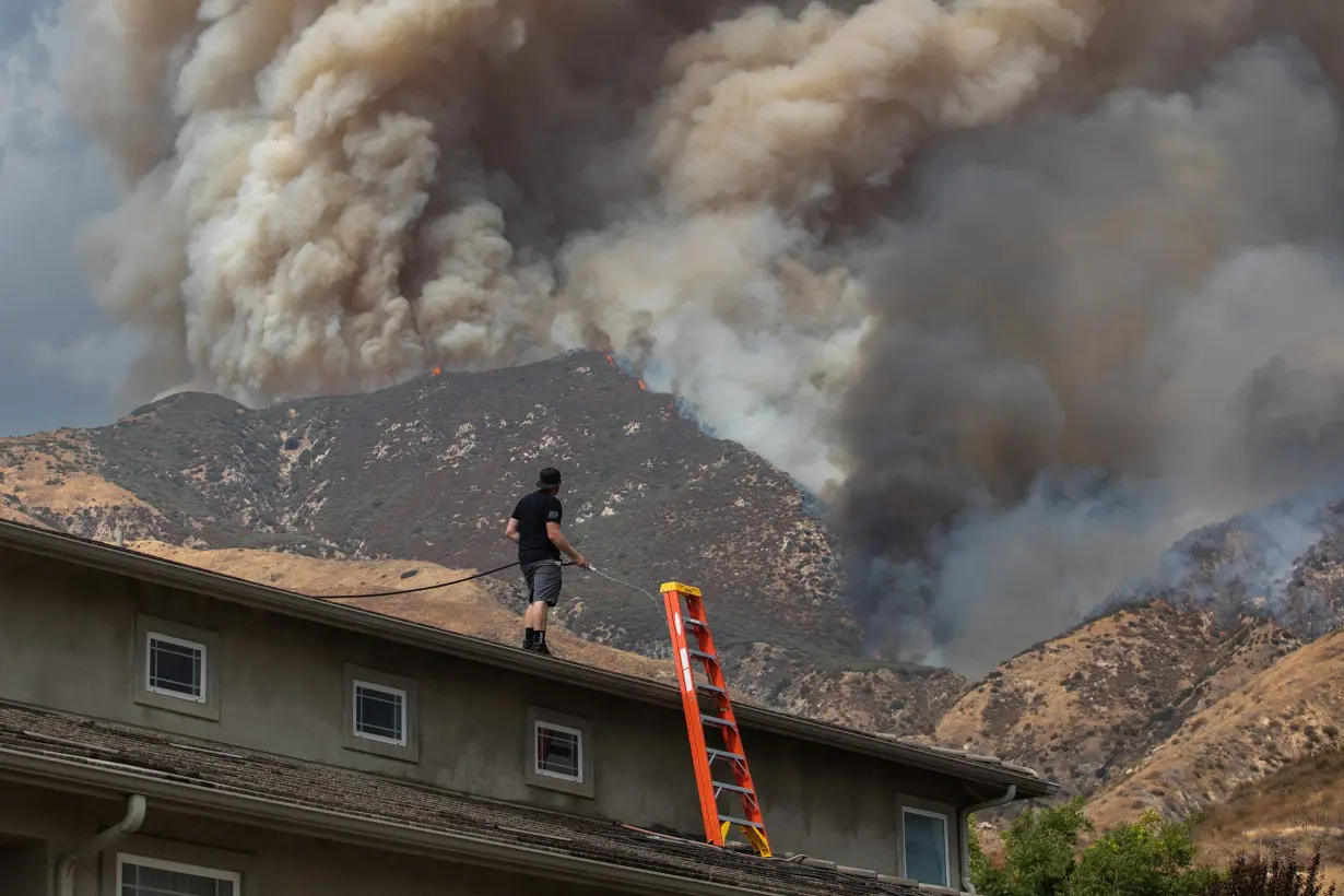 Residents flee as California and Nevada wildfires get dangerously close and forecasters warn of record heat