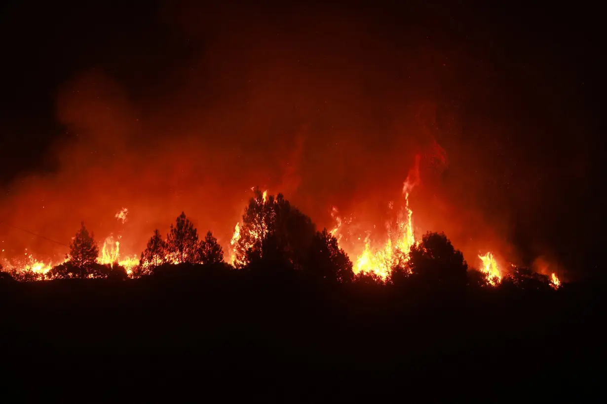 Residents flee as California and Nevada wildfires get dangerously close and forecasters warn of record heat