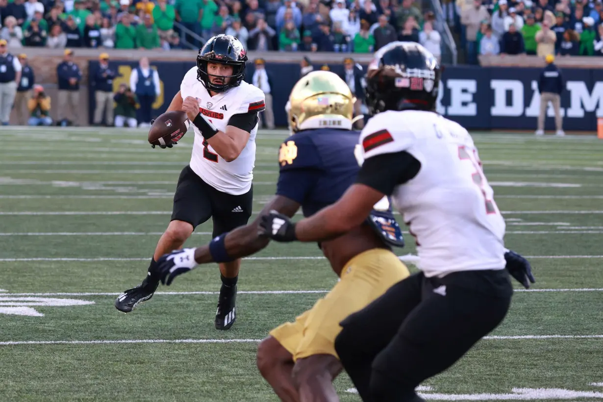 Northern Illinois quarterback Ethan Hampton (2) runs with the ball against Notre Dame.