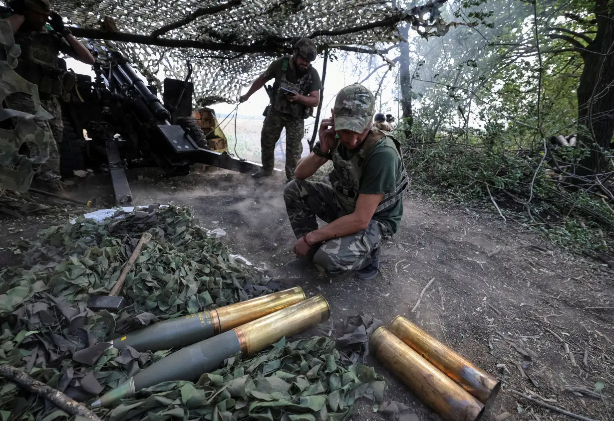 Artillerymen fire a howitzer towards Russian troops at a front line near Pokrovsk