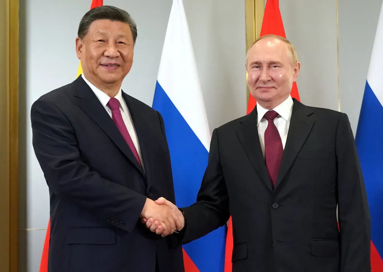 Russian President Putin and Chinese President Xi meet in Astana