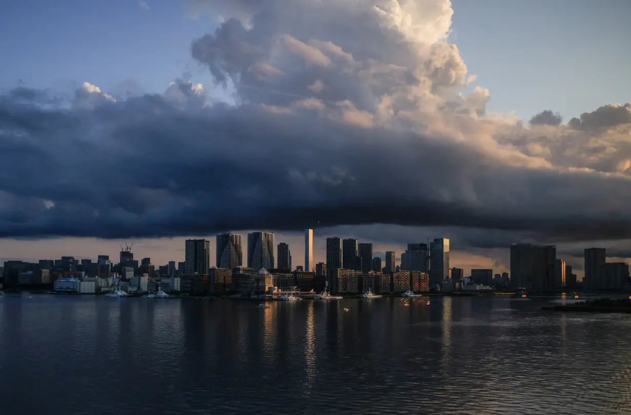 FILE PHOTO: City skyline and harbour are seen at sunrise from a bus window in Tokyo, Japan