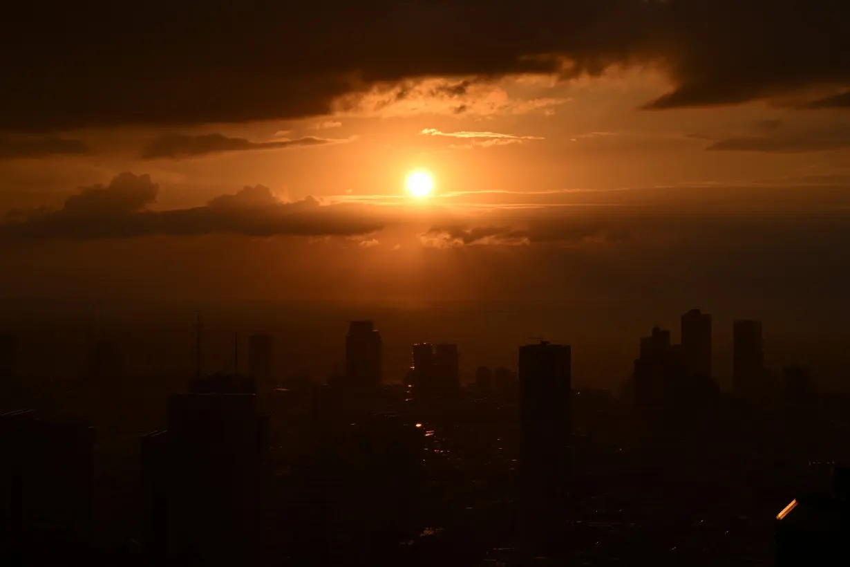 The sun sets over the Tel Aviv skyline