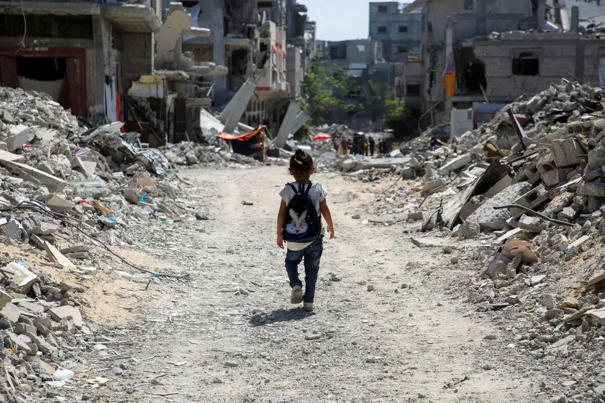 Gaza teacher welcomes students in a classroom tent set up on the rubble of her house