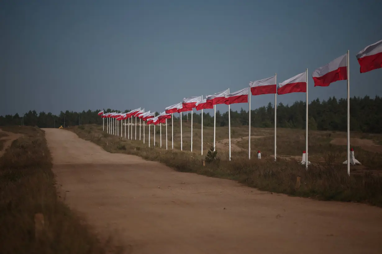 FILE PHOTO: The row of masts with Polish national flags is seen in Bemowo Piskie near Orzysz, Poland