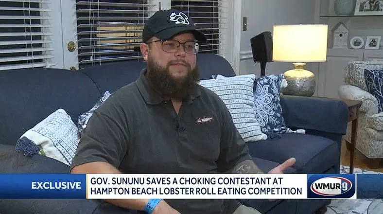 Gov. Chris Sununu saves a choking contestant at Hampton Beach Lobster Roll Eating Competition