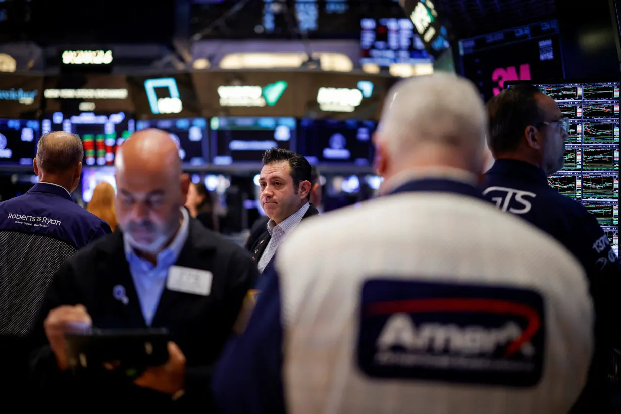 Traders work on the floor of the NYSE in New York