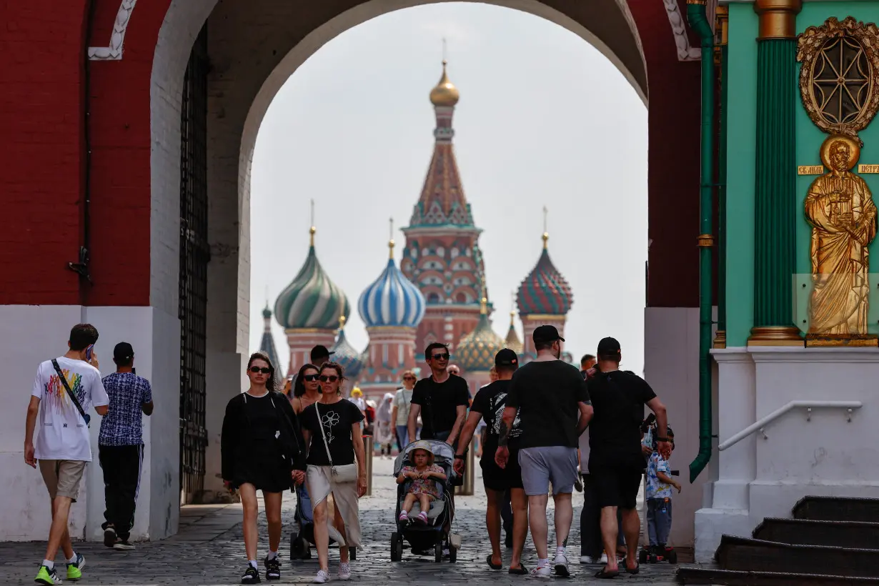 People walk near the Red Square in Moscow