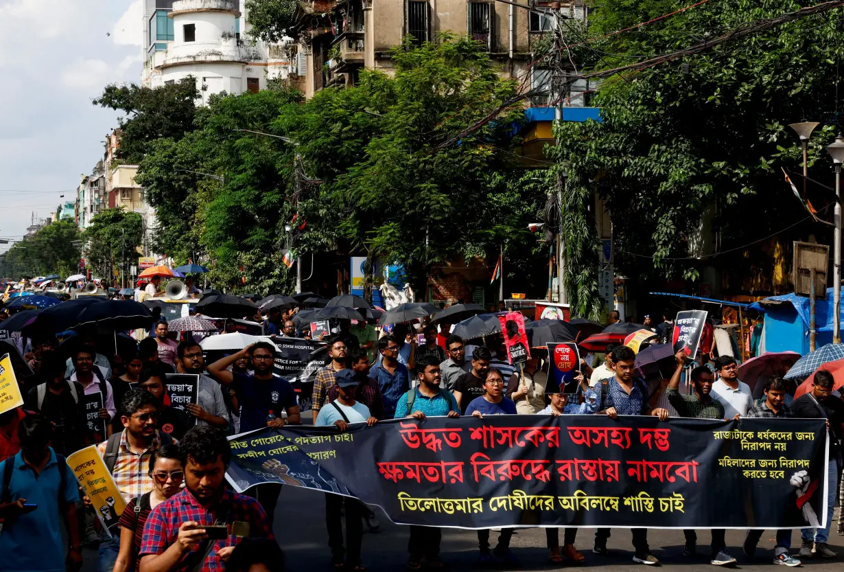 Medics march along a street during a protest condemning the rape and murder of a trainee medic at a government-run hospital, in Kolkata