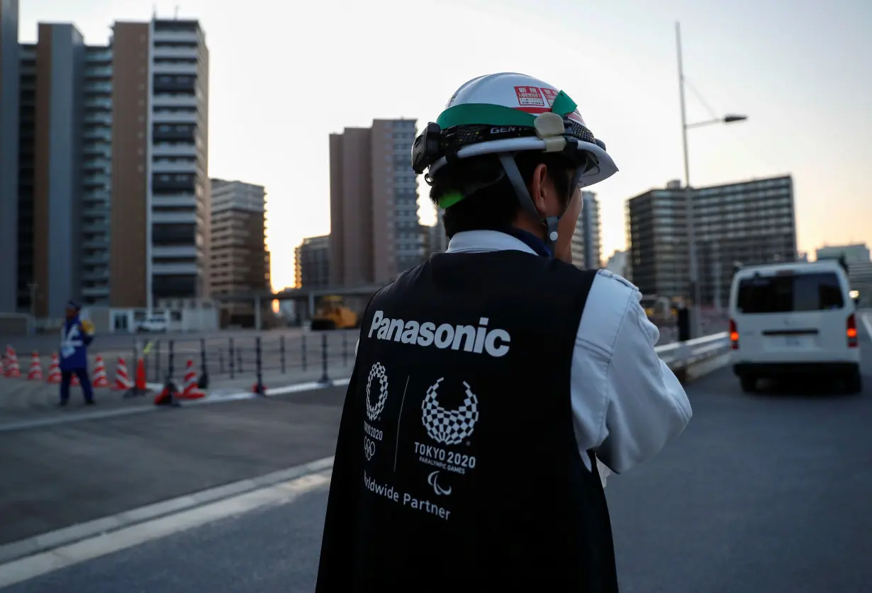 Worker wears a jacket with the logo of Panasonic, Tokyo 2020 Olympic and Paralympic Games' partner in Tokyo