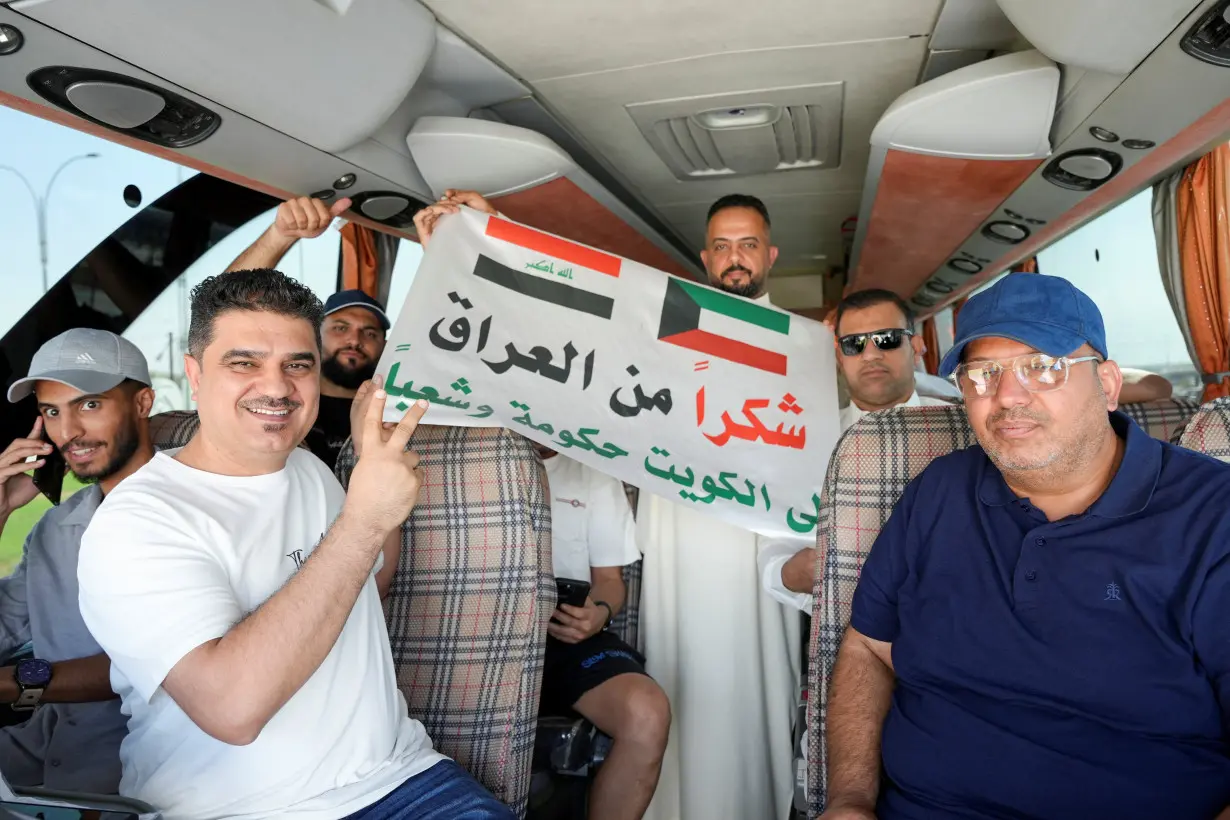 Iraqi fans gather in a bus before it heads to Kuwait, in Basra